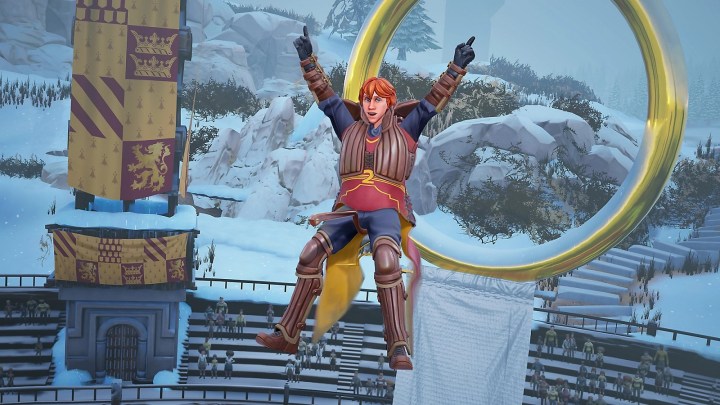 Harry Potter : Quidditch Champions ressemble à un jeu EA Sports 2 Ron Weasley (ou un autre rouquin ressemblant à Ron) volant sur son balai devant un but, les bras levés.
