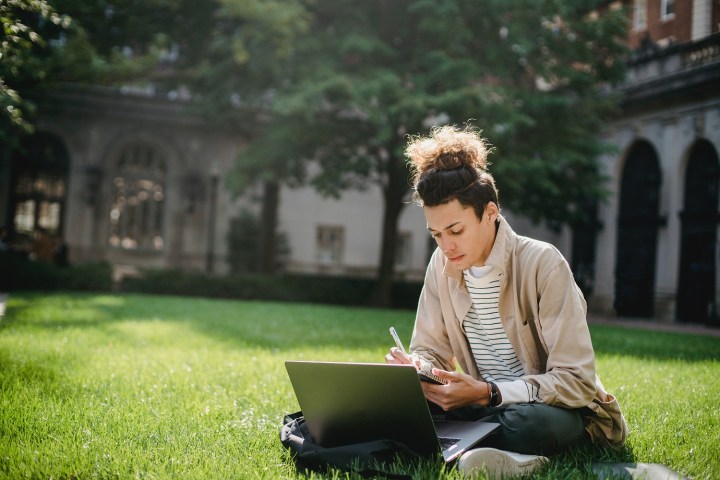 Comment soustraire dans Excel 2 comment soustraire dans excel personne assise sur l'herbe prenant des notes sur un laptop