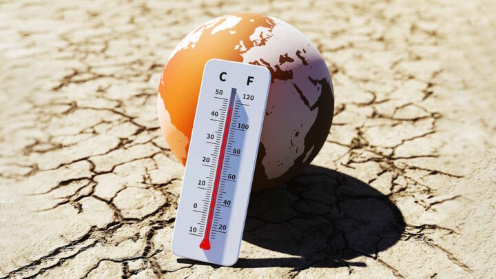 Spécialistes avertissent : préparez-vous à des années de chaleur intense ! 5 Imagem de um globo com um termómetro sob um solo seco, a representar o calor extremo
